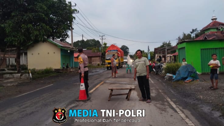 Bhabinkamtibmas Polsek Wonosobo dan Warga Negeri Agung BNS Gotong Royong Tutup Jalan Lubang Lintas Barat